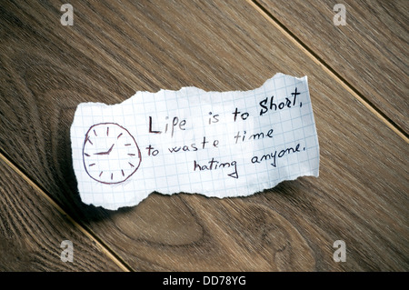 Motivational quote written on piece of paper, on a wood background. Stock Photo