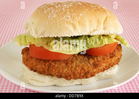 Chicken fillet burger in bread crumbs with lettuce and tomato on a fresh bread bun Stock Photo