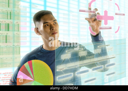Chinese man using illuminated touch screen Stock Photo