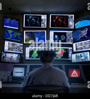 Police officer working in control room Stock Photo