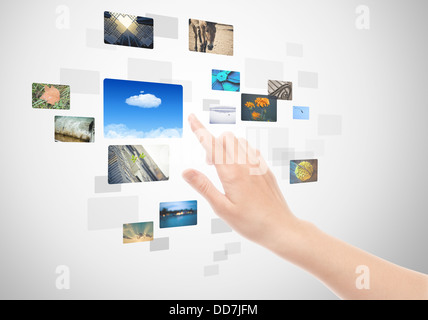 Hand Using Touch Screen Interface With Pictures Stock Photo