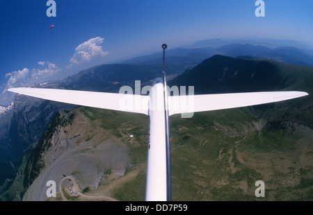 Glider plane Twin Astir flying with a paraglider over Punta Sesin near Canfranc, Aragon, Spain Stock Photo