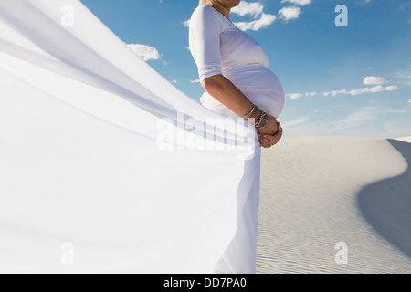 Pregnant Caucasian woman in desert Stock Photo