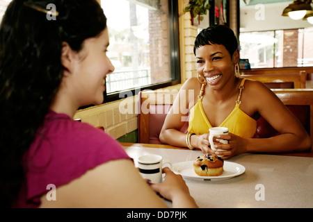 Women having coffee together in restaurant Stock Photo