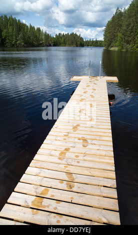 Wet footsteps on wooden pier , Finland Stock Photo