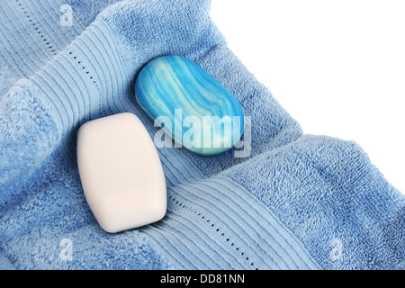 Towels and soaps on white background. Stock Photo