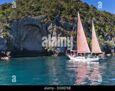 dh  LAKE TAUPO NEW ZEALAND Fearless sailing boat trip tourists Maori rock carving tour tourism Stock Photo