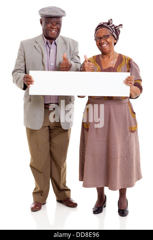 cheerful elderly African couple holding blank banner giving thumbs up Stock Photo