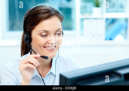Close-up image of a cheerful representative wearing a headset Stock Photo