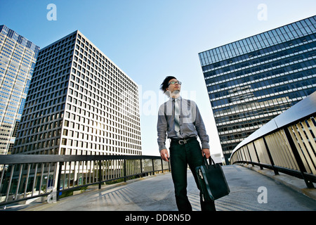 Asian businessman on urban walkway Stock Photo