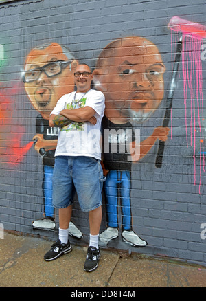 Portrait of a graffiti artist in front of his work at 5 Pointz in Long Island City, Queens, New York Stock Photo