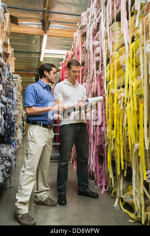 Workers talking in textile factory Stock Photo