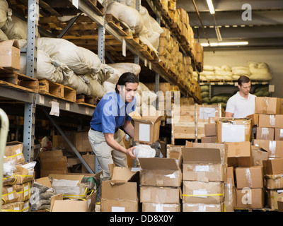 Workers stacking boxes in textile factory Stock Photo