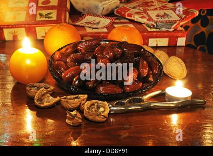 Dates in a shallow glass dish with Christmas presents to the rear, England, UK, Western Europe. Stock Photo