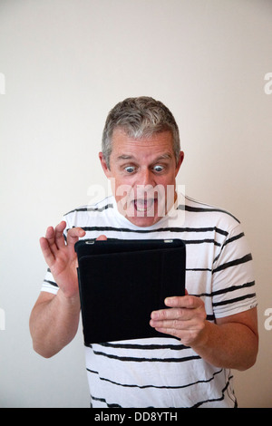 Excited man with Ipad Tablet Stock Photo