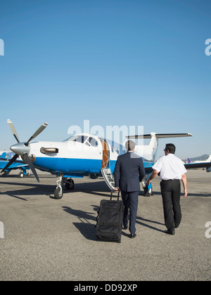 Caucasian businessmen walking on runway Stock Photo