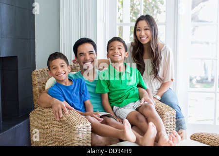 Family posing together in living room Stock Photo