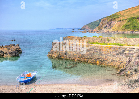 Single solo lonely boat in small harbour looking out to sea in creative hdr in Cornwall England Stock Photo