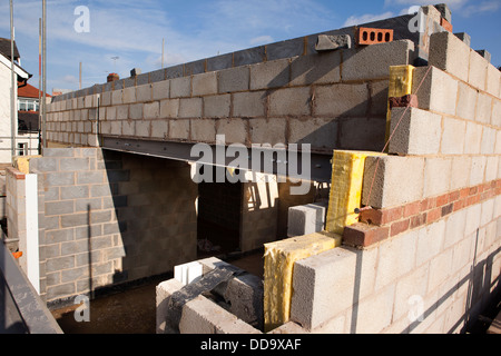 self building house, constructing upper floor, with traditional concrete block construction above steel lintel Stock Photo