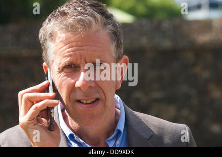 London, UK. 29th Aug, 2013. Stop The War Coalition's Chris Nineham takes a call as a small group of Stop The War activists demonstrate against military intervention in Syria as MPs debate options in Parliament. Credit:  Paul Davey/Alamy Live News Stock Photo
