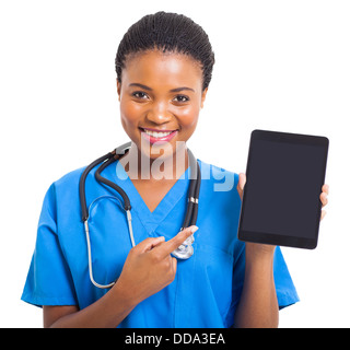 pretty African American nurse pointing tablet computer on white background Stock Photo