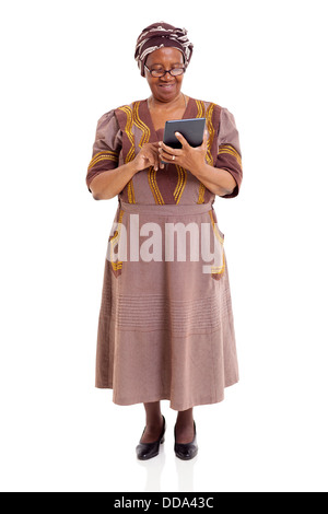 senior African woman using tablet computer isolated on white background Stock Photo