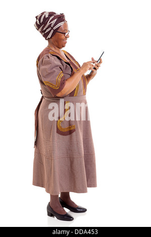 side view of African woman using tablet computer on white background Stock Photo
