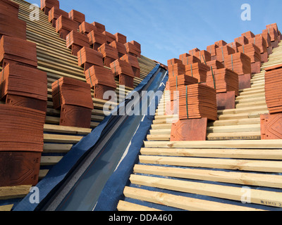 self building house, constructing roof, clay tiles stacked on wooden battens ready to be laid Stock Photo