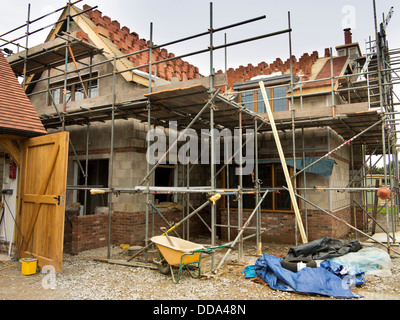 self building house, constructing roof, clay tiles stacked on laths ready to be laid Stock Photo