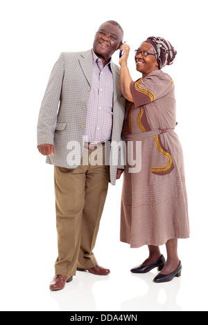 happy senior African couple using mobile phone isolated on white background Stock Photo