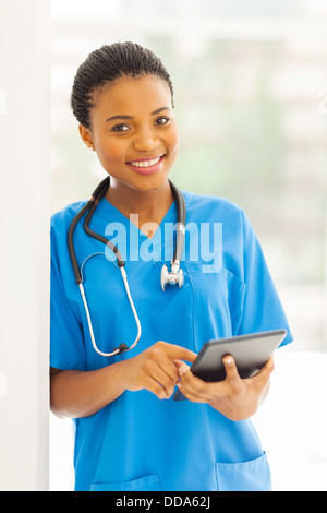 portrait of young African nurse using tablet pc Stock Photo