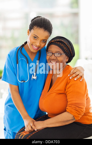 friendly caring young African nurse and senior patient Stock Photo