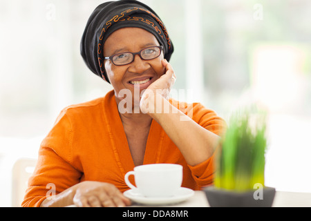 elegant senior African woman having tea at home Stock Photo