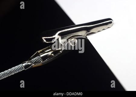 White piece of paper held by an alligator clip Stock Photo