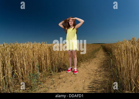 young girl looking around in the open countryside