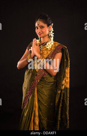 traditional indian female greeting with dark background Stock Photo