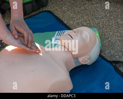 person practicing life saving technique CPR on a dummy on  a first aid  course Derbyshire England Stock Photo