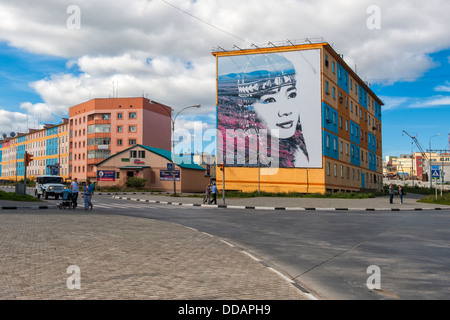Coloured apartment houses with mural of native Chukchi people, Siberian city Anadyr, Russian Far East Stock Photo