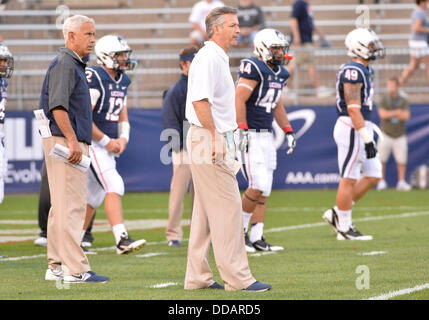 East Hartford, CT, USA. 29th Aug, 2013. Thursday August 29, 2013: Connecticut Huskies head coach Paul Pasqualoni and new Connecticut Huskies offensive co-ordinator TJ Weist look on before the start of the NCAA football game between Towson and Connecticut at Rentschler Field in East Hartford, CT. Towson upset Connecticut 33-18. Bill Shettle / Cal Sport Media Credit:  csm/Alamy Live News Stock Photo