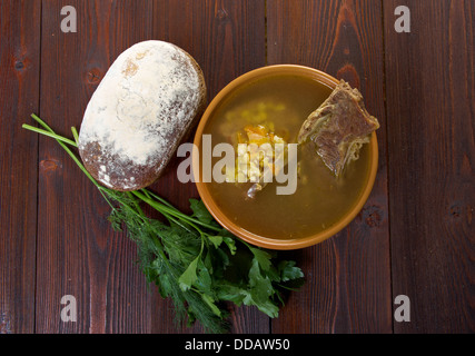 Pea soup with beef ribs and farmhouse bread,edible greens .farmhouse kitchen Stock Photo