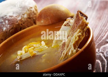 Pea soup with beef ribs and farmhouse bread,edible greens .farmhouse kitchen Stock Photo