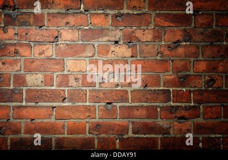 Background with brick wall and vignette and a clear field for the text Stock Photo