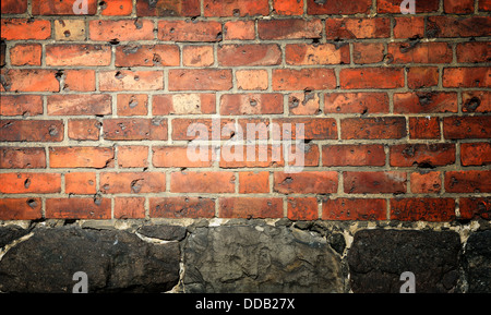 Wall background made of bricks and stones Stock Photo