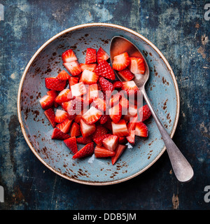 Rip Strawberry in plate on blue background Stock Photo