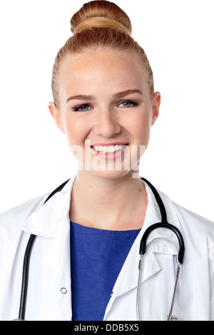 Smiling beautiful woman doctor with her hair in a neat bun and stethoscope around her neck looking directly at the camera with a sincere friendly smile Stock Photo