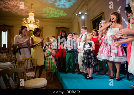 US First Lady Michelle Obama dances as Rachel Crow performs during the Kids' State Dinner in the East Room of the White House July 9, 2013 in Washington, DC. Stock Photo