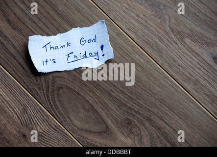 Friday message,written on piece of paper, on a wood background. Space for your text. Stock Photo