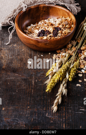 Muesli granola with raisin in wooden bowl Stock Photo