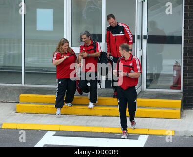 Cardiff, UK. Wednesday 28 August 2013  Pictured: Coaching staff with Morten Wieghorst (TOP) at Cardiff Airport.  Re: Swansea City FC players and staff en route for their UEFA Europa League, play off round, 2nd leg, against Petrolul Ploiesti in Romania. © D Legakis/Alamy Live News Stock Photo