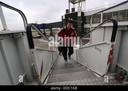 Cardiff, UK. Wednesday 28 August 2013  Pictured: Michael Laudrup boarding the team aeroplane at Cardiff Airport.  Re: Swansea City FC players and staff en route for their UEFA Europa League, play off round, 2nd leg, against Petrolul Ploiesti in Romania. © D Legakis/Alamy Live News Stock Photo